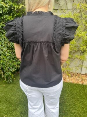 Gossia Black ruffle detail summer top with cap sleeves and relaxed fit Model Back