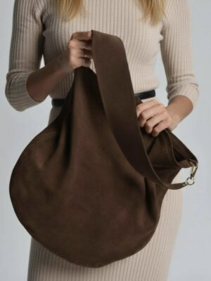Ana Suede Bag in chocolate. Close up image of model holding the bag.